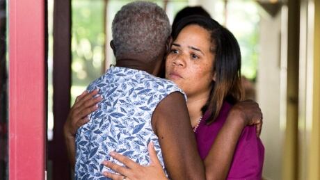 A hospital worker embraces a woman near the scene of a shooting at the Mercy Fitzgerald Hospital in Darby, Pa. on Thursday, July 24, 2014. A prosecutor said a gunman opened fire inside the psychiatric unit leaving one hospital employee dead and a second injured before being critically wounded himself. Philadelphia hospital shooting
