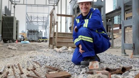 Michelle Wickham of Bison Historical Services Ltd. poses by railway artifacts unearthed during construction at ENMAX’s downtown substation. Enmax tool find calgary