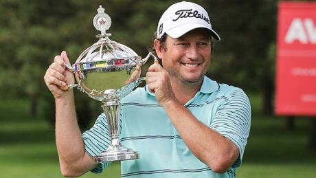 Tim Clark poses with the winner's trophy after capturing the Canadian Open at Royal Montreal in Ile Bizard, Que., on Sunday. clark-tim-140727