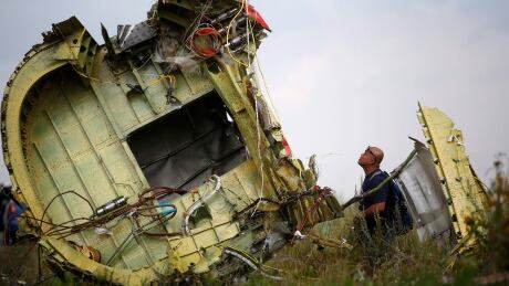 A Malaysian air crash investigator inspects the crash site of Malaysia Airlines Flight MH17, near the village of Hrabove (Grabovo), Donetsk region July 22, 2014. Almost 300 people were killed when the Malaysian airliner went down last Thursday. REUTERS/Maxim Zmeyev (UKRAINE - Tags: POLITICS TRANSPORT DISASTER CIVIL UNREST) - RTR3ZO7T Malaysia Airlines Flight MH17 Ukraine crisis