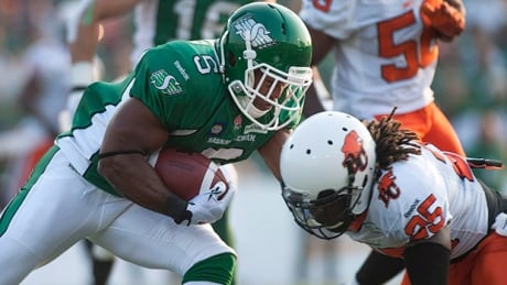 Roughriders running back Hugh Charles (5) collides with defensive back Ronnie Yell in a 26-13 loss to the Lions on July 12. charles-hugh-140712