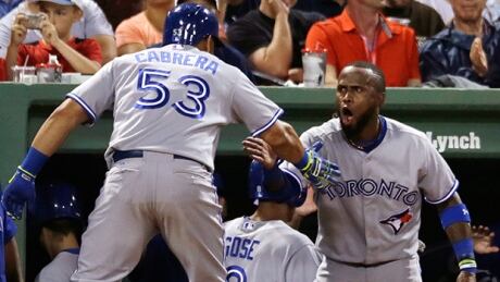 Jose Reyes, right, whoops it up after Melky Cabrera homered for the second time in Toronto's 14-1 rout of Boston on Monday. Blue Jays Red Sox Baseball