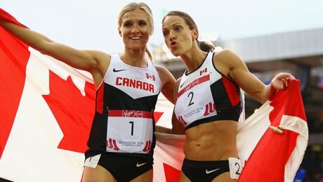 GLASGOW, SCOTLAND - JULY 30: (R-L) Silver medalist Jessica Zelinka of Canada and gold medalist Brianne Theisen-Eaton of Canada celebrate after the Women's Heptathlon 800 metres at Hampden Park during day seven of the Glasgow 2014 Commonwealth Games on July 30, 2014 in Glasgow, United Kingdom. theisen-zelinka-140730-620