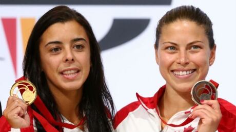 Canadians Meaghan Benfeito, left, and Roseline Filion pose with their medals (gold and bronze respectively) from the women's 10-metre platform event at the Commonwealth Games. The pair won gold in the women's 10-metre synchro platform earlier in the competition. Meaghan Benfeito, Roseline Filion