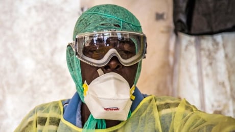 In this photo taken Monday, Aug. 11, 2014, a health worker examines patients for Ebola inside a screening tent, at the Kenema Government Hospital situated in the Eastern Province around 300 km, (186 miles), from the capital city of Freetown in Kenema, Sierra Leone. Over the decades, Ebola cases have been confirmed in 10 African countries, including Congo where the disease was first reported in 1976. But until this year, Ebola had never come to West Africa. Sierra Leone West Africa Ebola
