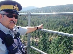 RCMP Const. Jacques Lefebvre points to Trout Creek canyon
