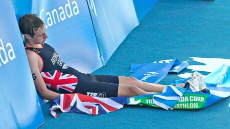 Alistair Brownlee of Great Britain collapses after crossing the finish line for a first-place win in Sunday's race at the ITU World Triathlon Grand Final in Edmonton. brownlee-britain