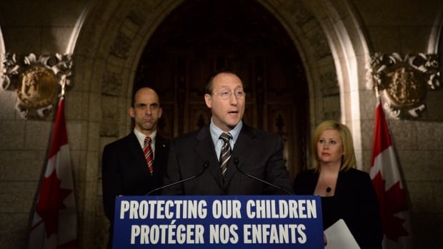 Justice Minister Peter MacKay speaks about cyberbullying as Public Safety Minister Steven Blaney, left, and Lianna McDonald of the Canadian Centre for Child Protection join him during Bullying Awareness Week last November. MacKay's cyberbullying bill, C-13, is moving through the Commons, but faces some opposition over privacy concerns.