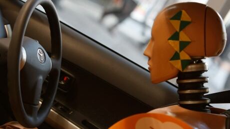 A crash test dummy is displayed inside a Toyota vehicle at its showroom in Tokyo February 3, 2010. A major manufacturer of dummies in the U.S. is making bigger models to better match the obese American population. crash test dummy