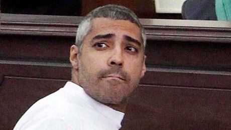 Mohammed Fahmy is pictured in a Cairo courtrrom on March 31, 2014. Lawyers for Fahmy , an Egyptian-Canadian journalist imprisoned in Cairo, have written to Prime Minister Stephen Harper, imploring him to take action that would help secure the man's release. Mohammed Fahmy 20141212