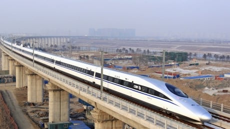 A high-speed train passes over Yongdinghe Bridge in Beijing. China's two largest train makers are merging in a bid to win international contracts. China High Speed Train