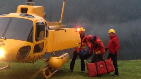 Members of the North Shore Rescue team board a helicopter in North Vancouver to resume the search for Liang Jin on Tuesday morning. North Shore Rescue
