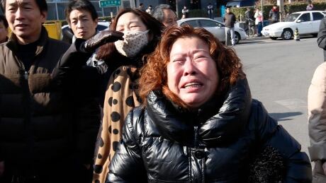 A family member of a passenger onboard the missing Malaysia Airlines flight MH370, cries during a protest demanding the Malaysian government to keep searching the missing flight, in front of the Malaysian Embassy in Beijing on Jan. 29, 2015. MALAYSIA-AIRLINES/DISASTER