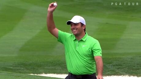 Francesco Molinari of Italy holds up the ball he used to hit a hole-in-one on the par-3 16th hole at the Pheonix Open Saturday. Francesco Molinari