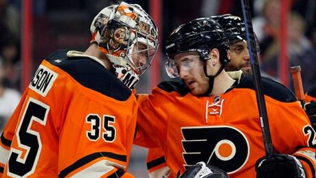 Philadelphia Flyers goalie Steve Mason, left, and winger Matt Read celebrate the win over the Toronto Maple Leafs Saturday night. steve-mason