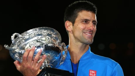 Novak Djokovic holds the Norman Brookes Challenge Cup after winning his men's final match against Andy Murray at the Australian Open on Sunday. djokovic-novak