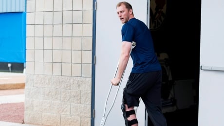 Michael Saunders departs the Blue Jays' Dunedin clubhouse on crutches after tearing his meniscus in a freak spring training accident. The Victoria, B.C. outfielder had surgery Friday. Michael Saunders