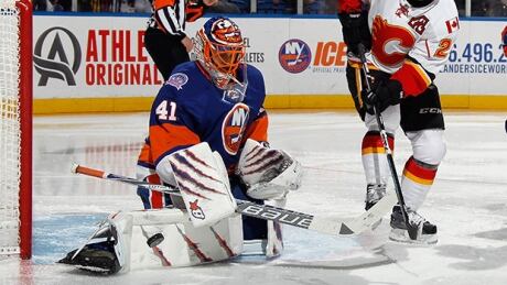 Jaroslav Halak of the New York Islanders makes the third period save on Jiri Hudler of the Calgary Flames at the Nassau Veterans Memorial Coliseum on Friday in Uniondale, New York. Halak set an Islander record for most wins in a season with 33. Jaroslav Halak