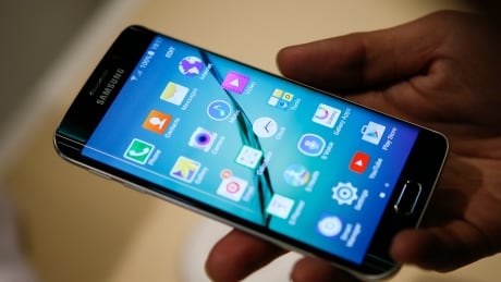 In this Monday, Feb. 23, 2015 photo, two new Samsung phones, Galaxy S6, left, and Galaxy S6 Edge, right, are shown at a special press preview in New York. Samsung officially unveiled the stylish new phones on Sunday, March 1, 2015, the eve of this week's Mobile World Congress wireless show in Barcelona, Spain. (AP Photo/Bebeto Matthews) Wirelesss Show Flagship Phone