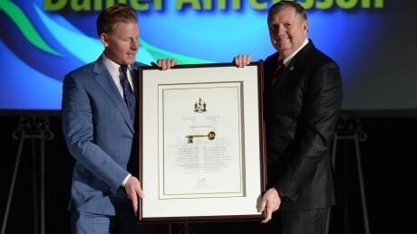 Former Ottawa Senators captain Daniel Alfredsson is presented with the Key to the City by Ottawa Deputy Mayor Bob Monette at Ottawa City Hall in Ottawa on Thursday. Daniel Aflredsson