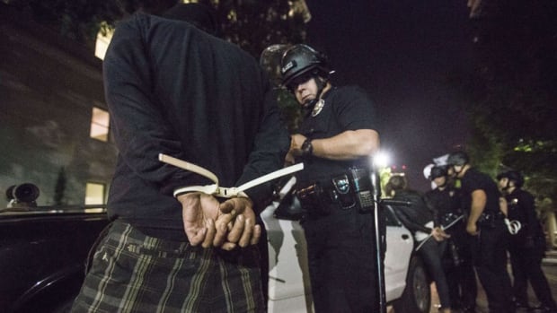 A demonstrator is arrested in Los Angeles during demonstrations against a decision by a Ferguson, Missouri grand jury to not indict a white police officer in the shooting of black teenager Michael Brown.