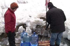 People collecting spring water
