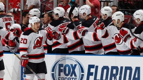 New Jersey Devils forward Jordin Tootoo (20) is congratulated by teammates after scoring a second period goal during an NHL hockey game against the Florida Panthers, Saturday, April 11, 2015, in Sunrise, Fla. (AP Photo/Joel Auerbach) Devils Panthers Hockey