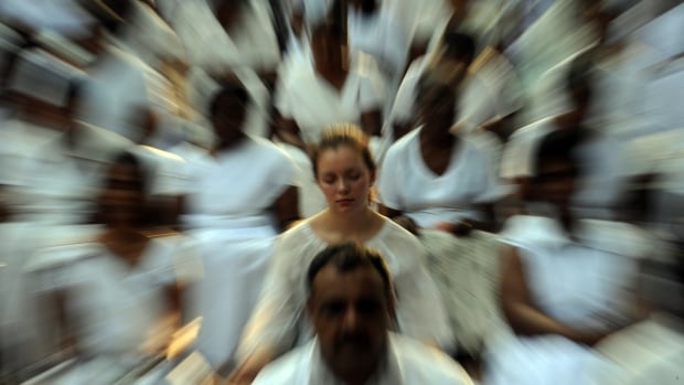 A foreign election observer (centre), together with Sri Lankan citizens, meditate during a special public meditation and prayer gathering organised for a peaceful election in Colombo on January 24, 2010.