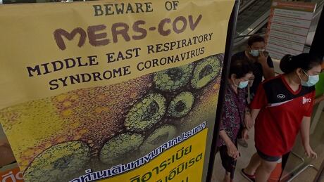 Thai people walk past an information banner on Middle East Respiratory Syndrome (MERS) at the entrance of Bamrasnaradura Infectious Diseases Institute in Nonthaburi province on June 19, 2015. Thailand on June 18 said a 75-year-old man from Oman was confirmed to have MERS in Southeast Asia's first case of the virus since an outbreak in South Korea that has killed 23 people. MERS Thailand