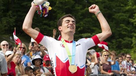 Canada's Raphael Gagne reacts after receiving his gold medal for winning the men's mountain bike final at the Hardwood Mountain Bike Park in Oro-Medonte, Ont. at the 2015 Pan Am Games on Sunday, July 12, 2015. gagne-raphael-150712-620