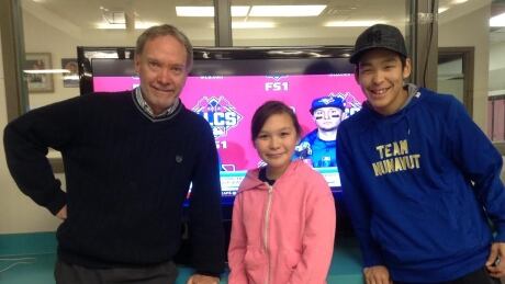 Teacher John Hudson and his students Mackenzie Demerah and Marcus Kokak. They've been crowding in the library at Kugluktuk High School to watch the Toronto Blue Jays' playoff run. Kugluktuk Blue Jays fans