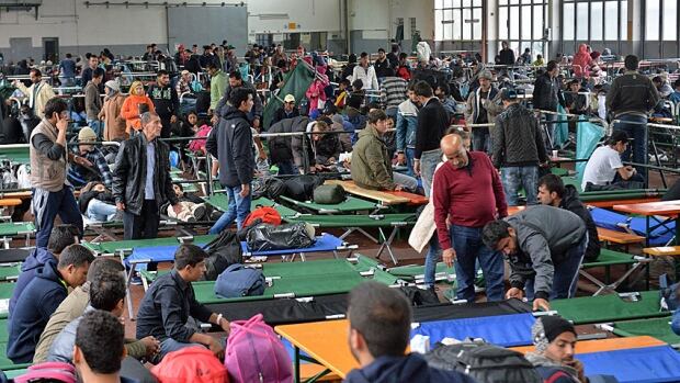 Refugees wait in a crowded migrant registration centre in Passau, southern Germany. Trying to document the continued inflow of asylum seekers has proved overwhelming for German authorities.