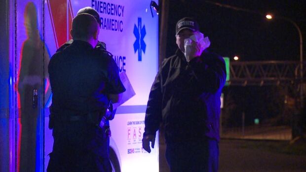A security guard nurses his face with a bag of ice, after a violent altercation outside the Turf Pub in Surrey, Thursday morning.