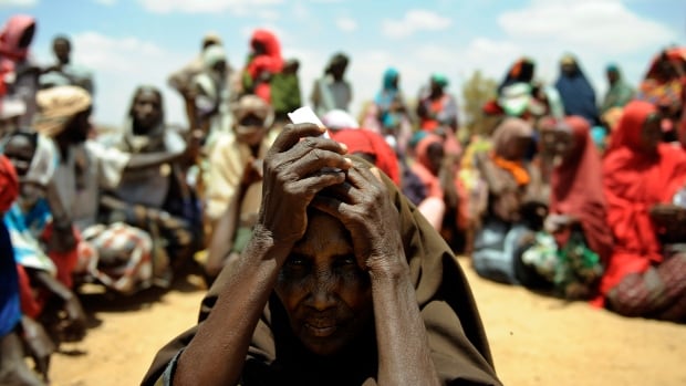 A newly arrived elderly Somali woman waits with other new arrivals to be registered as refugees in Doolow, south western Somalia. Doolow is the main exit point for Somalis from Bay, Bakool and Gedo regions fleeing to Ethiopia to escape war and a severe drought ravaging the country.