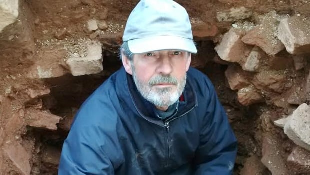 Parks Canada archaeologist Charles Burke excavating part of the cellar of home built by Colonel Joseph Morris at the Fort Lawrence National Historic Site along the Nova Scotia-New Brunswick border.