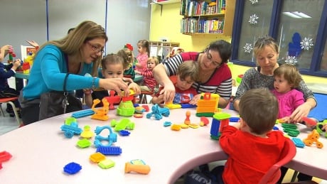 Many parents, like these mothers playing with their children at a daycare, are unprepared for the tax bill they'll get to cover the increase in fees that went into effect in April 2015. Daycare