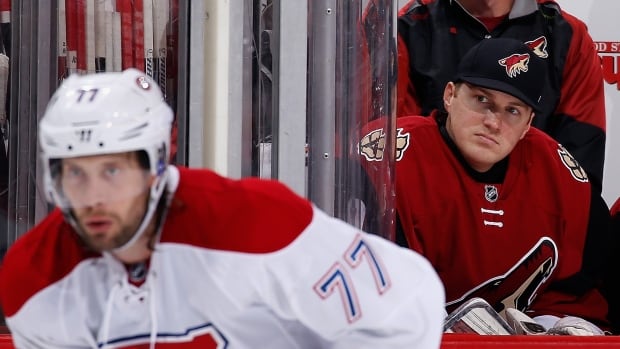 Emergency goalie Nathan Schoenfeld of the Arizona Coyotes watches from the bench during the third period of the NHL game against the Montreal Canadiens at Gila River Arena on February 15, 2016 in Glendale, Arizona. The Coyotes defeated the Canadiens 6-2.