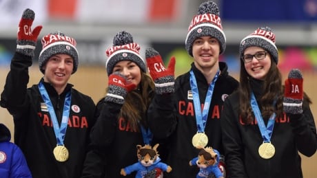 Canadians Sterling Middleton, Karlee Burgess, Tyler Tardi and Mary Fay (left to right) stand on the medal podium after winning the gold medal game of the curling mixed team finals at Winter Youth Olympic Games. canada-curling-160217