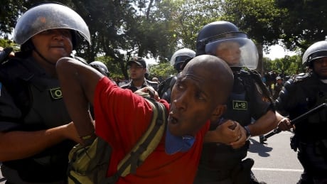 A squatter is detained as he is evicted from an abandoned building in Flamengo neighborhood, in Rio de Janeiro April 14, 2015. Dozens of riot police removed squatters from a derelict building in Rio de Janeiro, which was supposed to be turned into a luxury hotel for the Olympic Games by Brazil's once-richest-man Eike Batista, whose oil and mining empire collapsed. BRAZIL-RIO/SQUATTERS