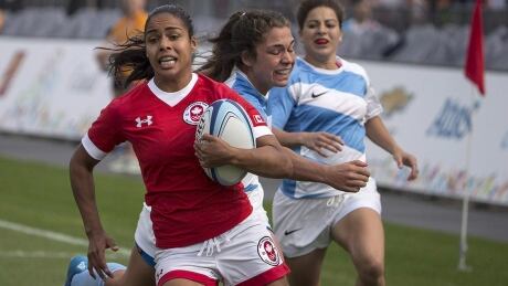 Magali Harvey, left, helped the Canadian women's rugby sevens team win gold at last year's Pan Am Games in Toronto. harvey-magali-150712-1180