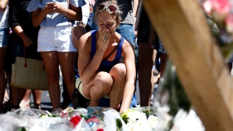 A woman reacts as she places flowers in front of the memorial set on the 'Promenade des Anglais' where the truck crashed into the crowd during the Bastille Day celebrations in Nice, France, 15 July 2016. According to reports, at least 84 people died and many were wounded after a truck drove into the crowd on the famous Promenade des Anglais during celebrations of Bastille Day in Nice, late 14 July. Anti-terrorism police took over the investigation in the incident, media added. FRANCE NICE TRUCK TERROR ATTACKS AFTERMATH
