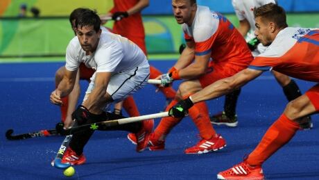 Canada's Iain Smythe, left, tries to break past the Netherlands' defence during a men's field hockey match at the 2016 Summer Olympics in Rio de Janeiro, Brazil Tuesday. Canada Netherlands men's field hockey