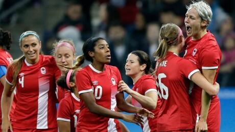 Canada's Sophie Schmidt, right, celebrates scoring her team's goal in a 1-0 quarter-final win over France. canada-soccer-1180
