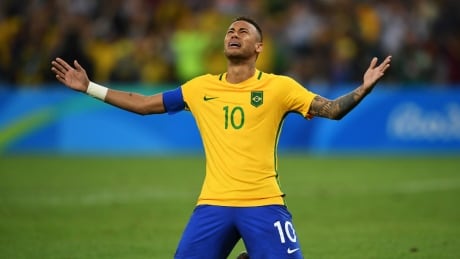 Neymar of Brazil celebrates scoring the winning penalty in the penalty shoot out during the Men's Football Final between Brazil and Germany. Neymar Brazil gold soccer