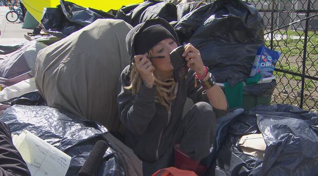 Kati Mather with makeup in pile of bags