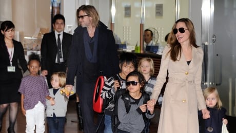 Accompanied by their six children, US movie stars Brad Pitt and Angellina Jolie appear before photographers upon their arrival at Haneda Airport in Tokyo on November 8, 2011. Brad Pitt is here for the Japan premiere of his last film 'Moneyball'. Hkg5557488