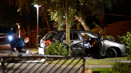 Police technicians examine the car the injured were travelling in after a shooting in the southern part of Malmo, Sweden on Sunday. SWEDEN SHOOTING