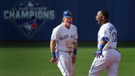 Toronto Blue Jays designated hitter Edwin Encarnacion (10, right) celebrates his ninth-inning hit to win the game with Toronto Blue Jays third baseman Josh Donaldson (20). edwin