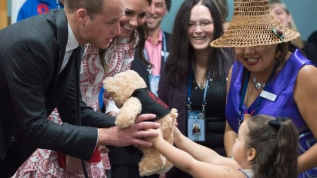 The Duke and Duchess of Cambridge receive teddy bears from five-year-old Hailey Cain during a tour of Sheway, a centre that provides support for native women, in Vancouver, B.C., Sunday, Sept. 25, 2016. Royal Visit 20160925