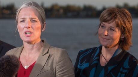 Catherine McKenna, left, federal Minister of Environment and Climate Change, announces the approval of the Pacific NorthWest LNG project on Tuesday evening at the Sea Island Coast Guard Base, in Richmond, B.C., as Premier Christy Clark looks on.
McKenna-Clark
